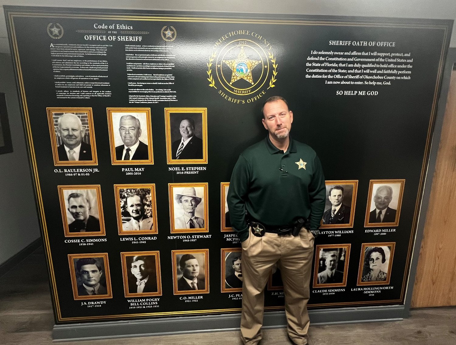 Criminal Investigations Lt. Chris Hans poses with his mural.